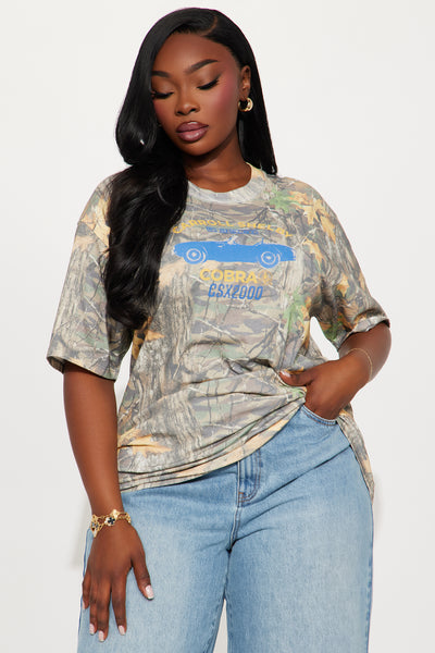 https://cdn.shopify.com/s/files/1/0293/9277/files/05-21-25_S3_29_WSHEL007AO_Camouflage_AE_SS_13-38-46_PLUS_29260_PXF.jpg?v=1747958240&with=400&height=600